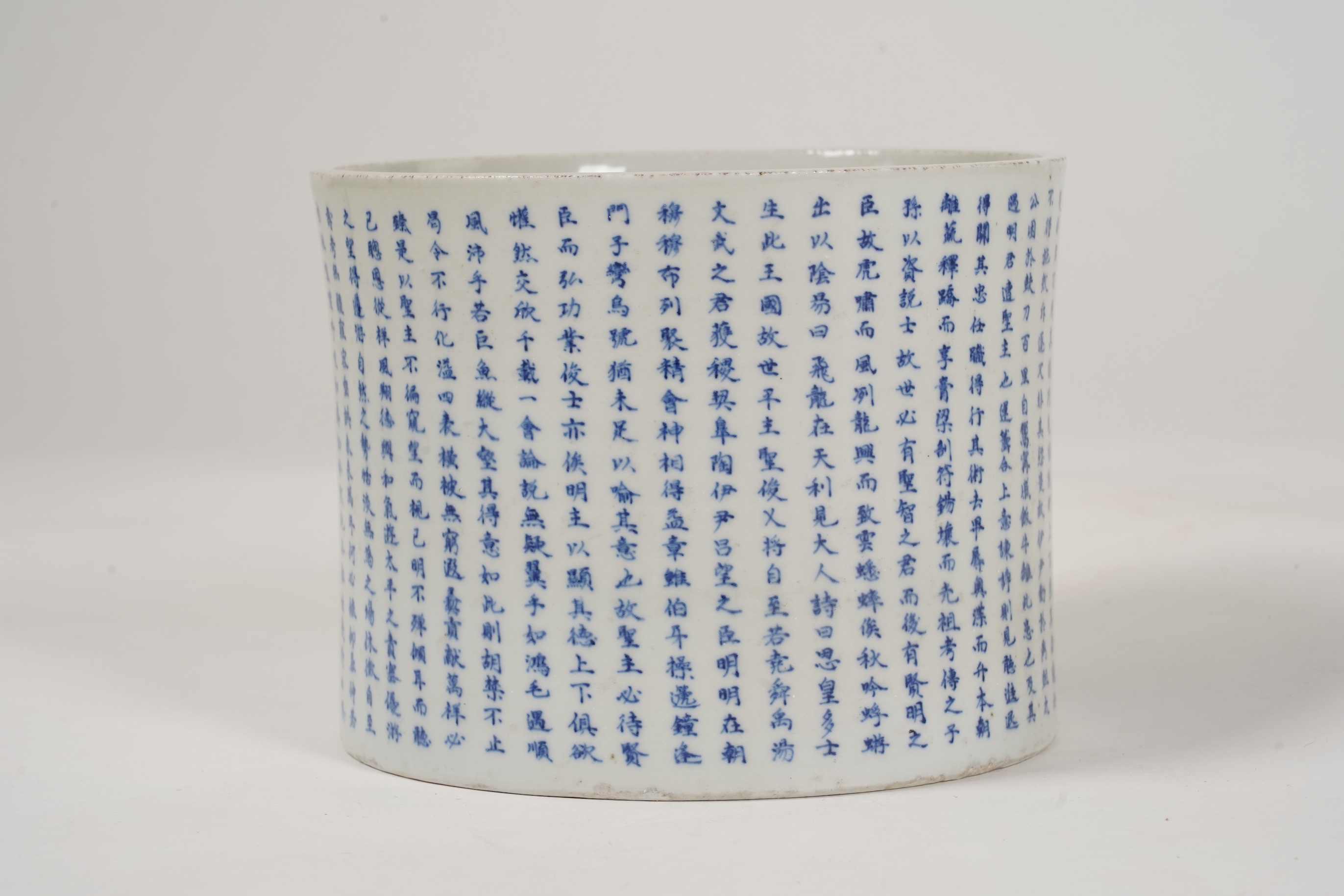 A Chinese underglaze blue and copper red inscribed brush pot, possibly Kangxi period